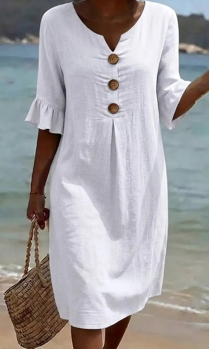 Robe femme en coton lin boutonnée, manches volantées, style estival fluide pour plage et vacances.