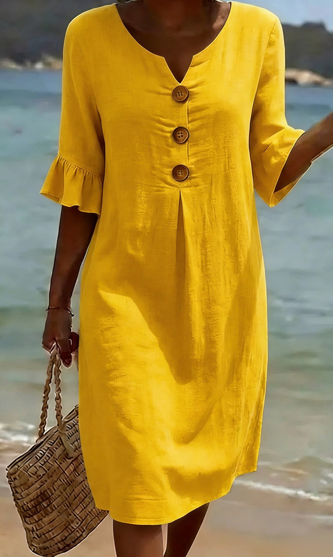 Détail de la robe femme en coton lin: boutonnage élégant et manches volantées pour un look estival.