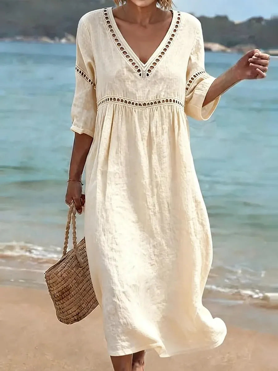 Robe d'été femme en coton, col V, coupe fluide et mi-longue pour un confort optimal. Style décontracté et estival.