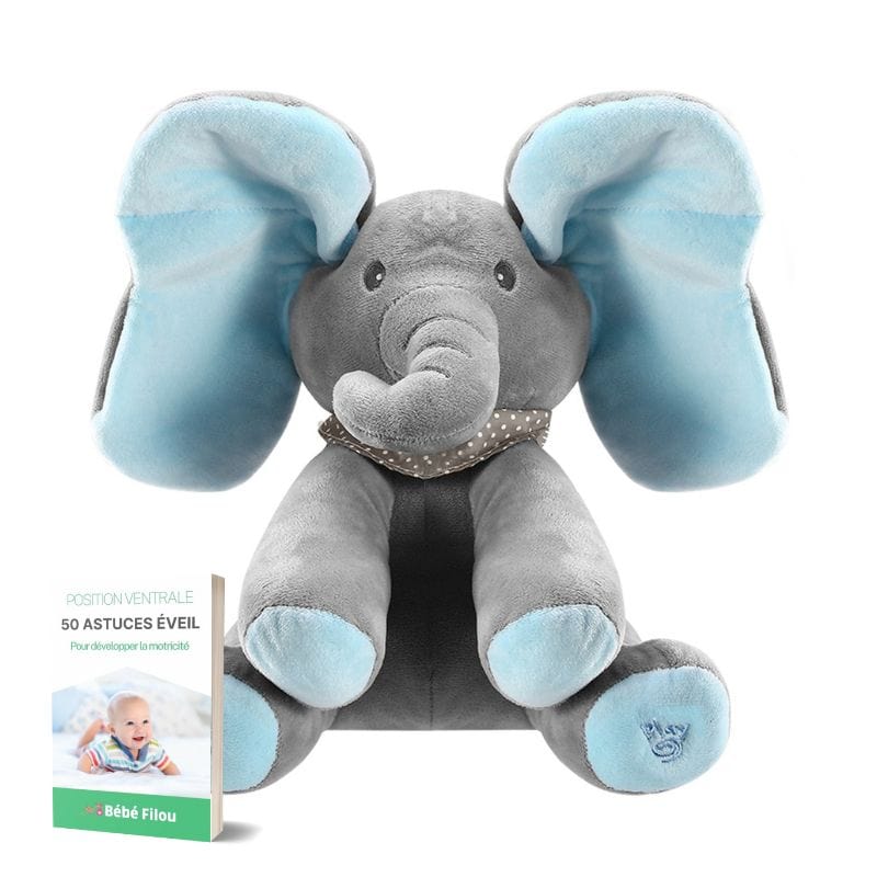 Bébé joue avec la peluche éléphant Bibou interactive, explorant les mélodies et les textures douces.