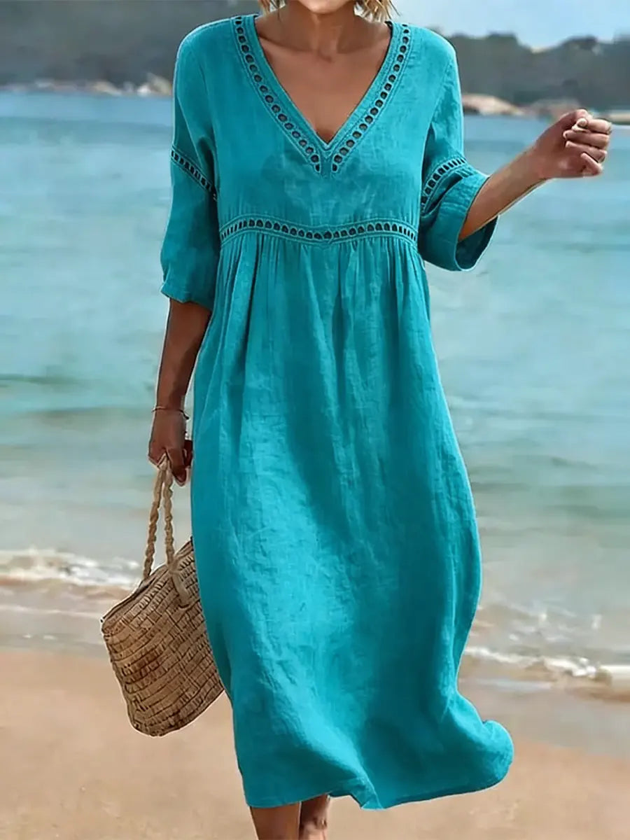 Robe femme en coton à manches courtes et col V, coupe fluide. Idéale pour un look estival décontracté et polyvalent.