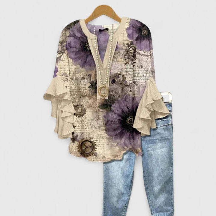 Blouse élégante femme fleurie, manches volants, coupe confortable, pour un look chic décontracté.