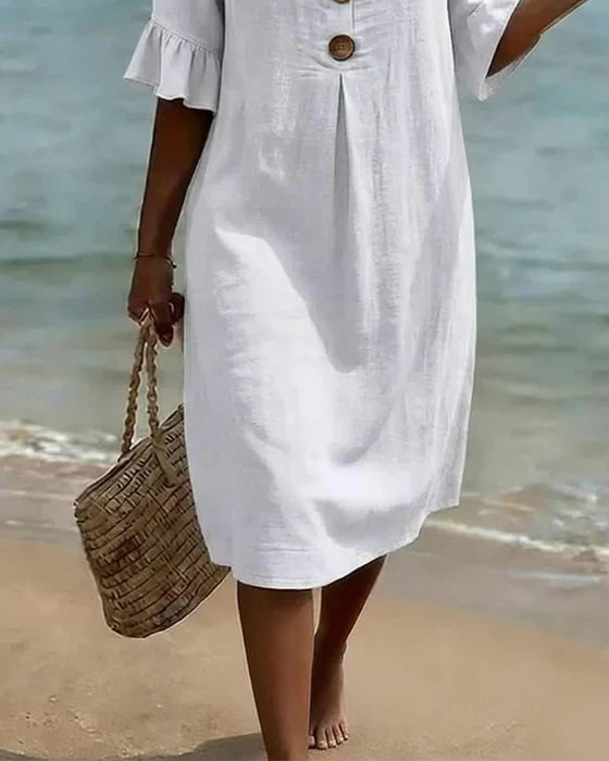 Robe femme fluide en coton lin respirant, boutonnée, manches volantées. Confort estival garanti.