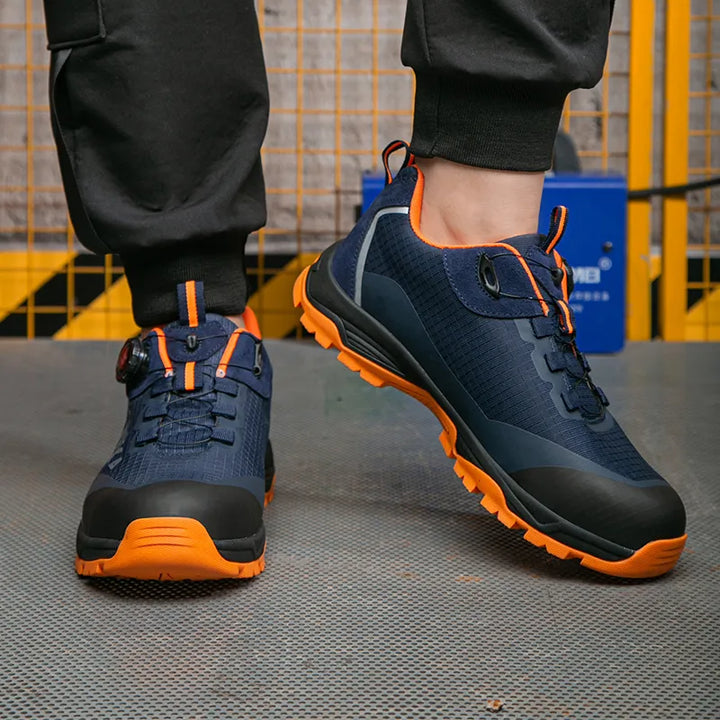 Semelle antidérapante et anti-perforation des baskets de sécurité H/F orange/noir, essentielles pour l'industrie.