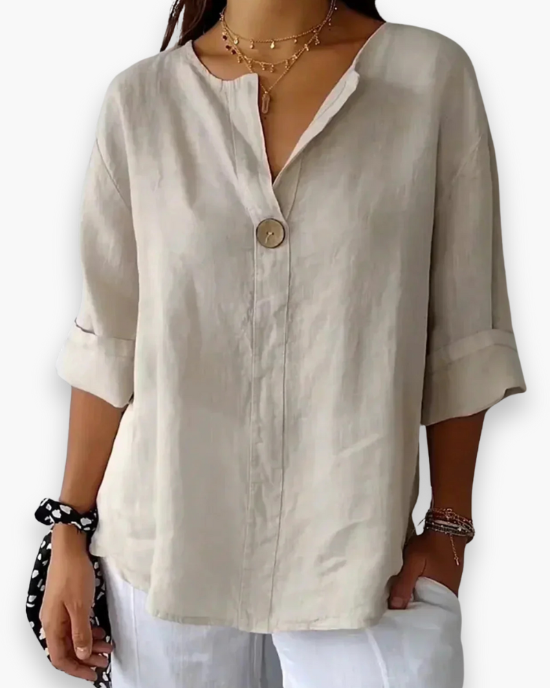 Blouse ample élégante femme, col V subtil et manches fluides, tissu léger, style chic et décontracté.