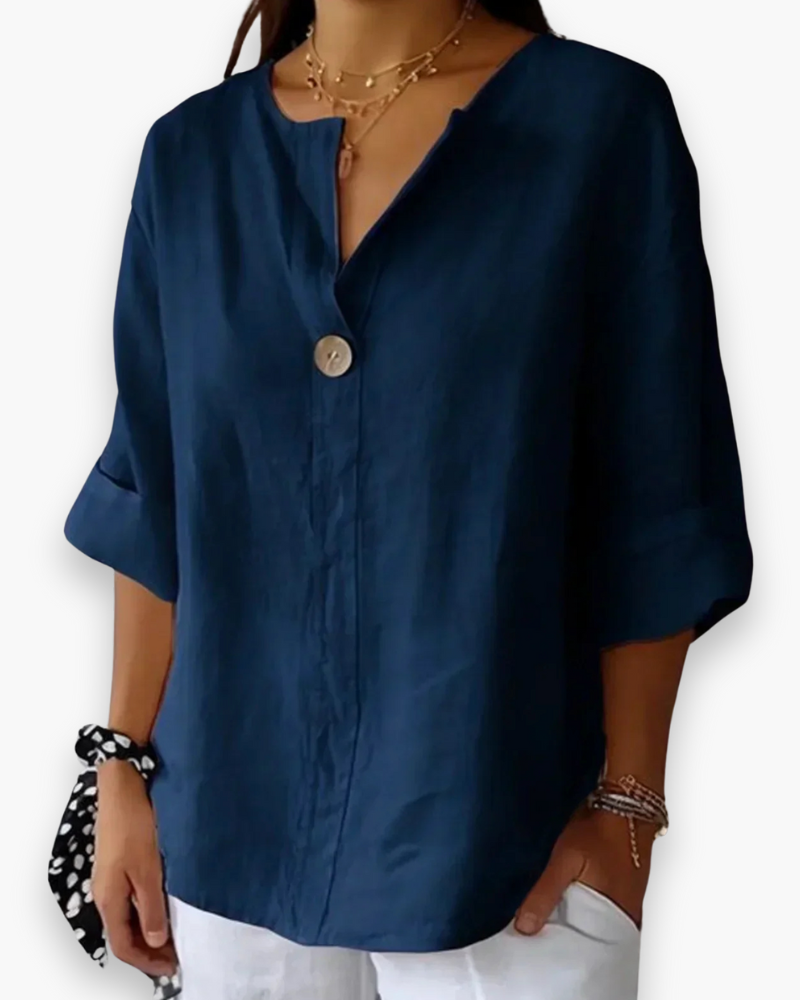 Blouse ample élégante femme, col V subtil et manches fluides, tissu léger, style chic et décontracté.