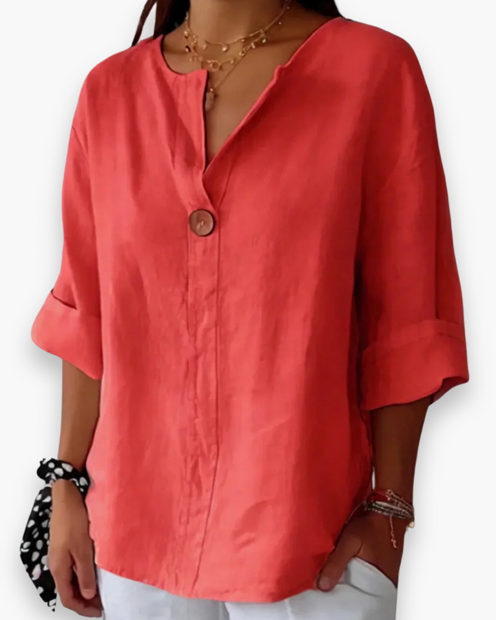 Blouse ample élégante femme, col V subtil et manches fluides, tissu léger, style chic et décontracté.
