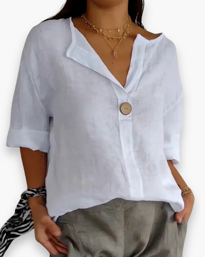 Blouse ample élégante femme, col V subtil et manches fluides, tissu léger, style chic et décontracté.