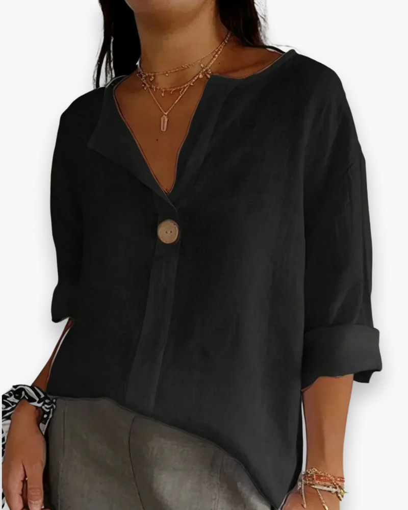 Blouse ample élégante femme, col V subtil et manches fluides, tissu léger, style chic et décontracté.