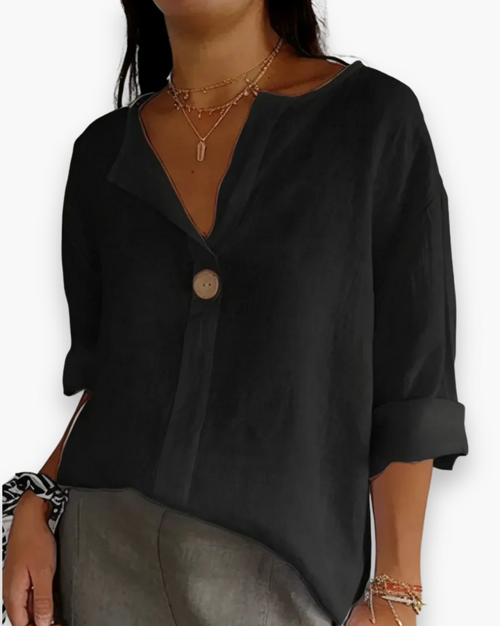 Blouse ample élégante femme, col V subtil et manches fluides, tissu léger, style chic et décontracté.