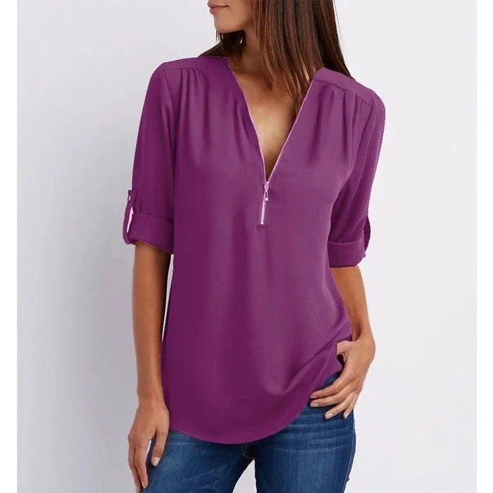 Blouse mode femme grande taille, ample, fermeture éclair stylée, manches 3/4. Style contemporain et féminin.