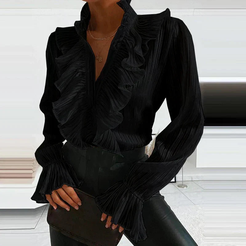 Haut femme féminin à volants et boutons. Blouse élégante à manches longues, parfaite pour une tenue chic.