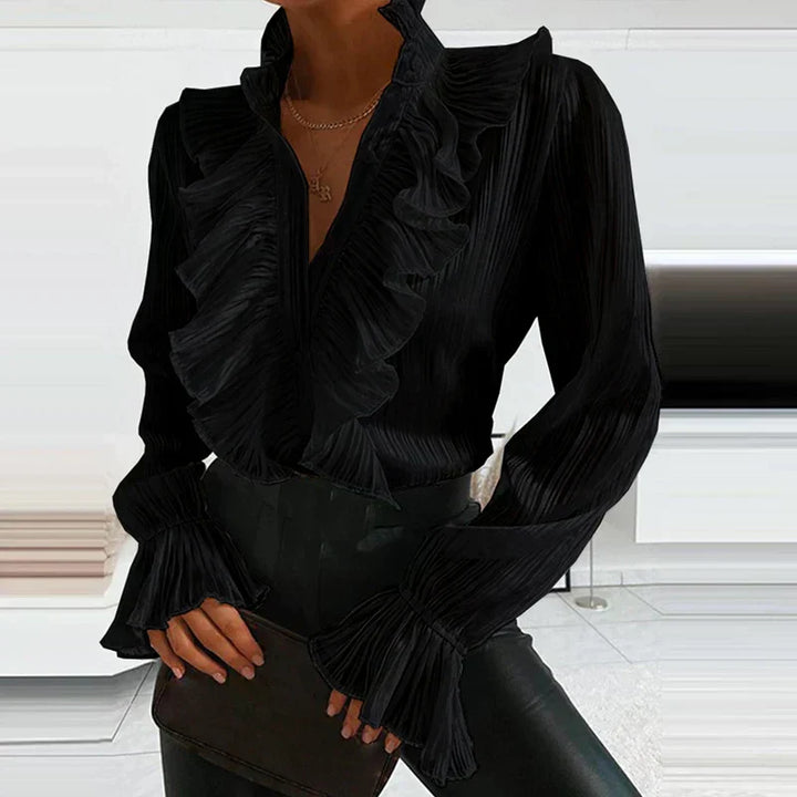 Haut femme féminin à volants et boutons. Blouse élégante à manches longues, parfaite pour une tenue chic.