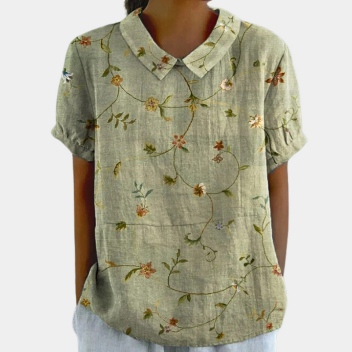 "Blouse femme manches courtes imprimé fleuri pastel, col rond, couleur abricot, chic et confortable pour un style décontracté