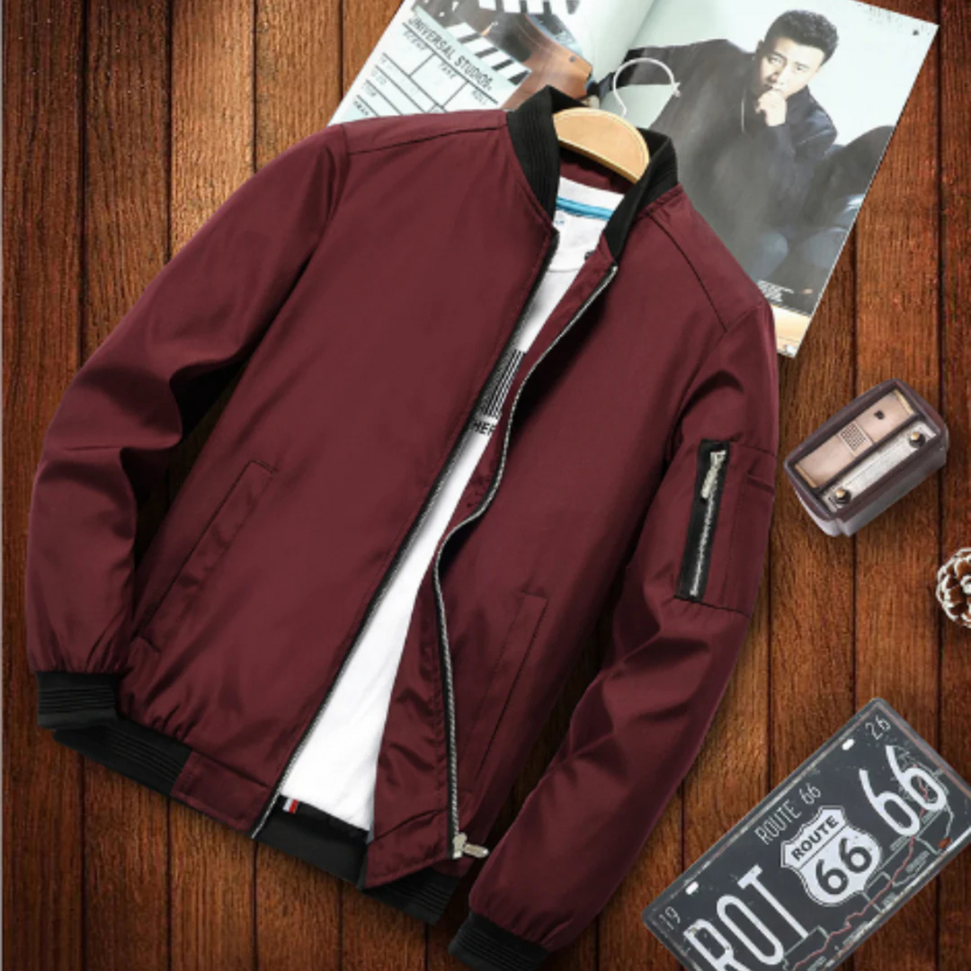 "Blouson bomber homme multi-poches urbain, coupe-vent, élégant, couleur foncée, style décontracté et chic."