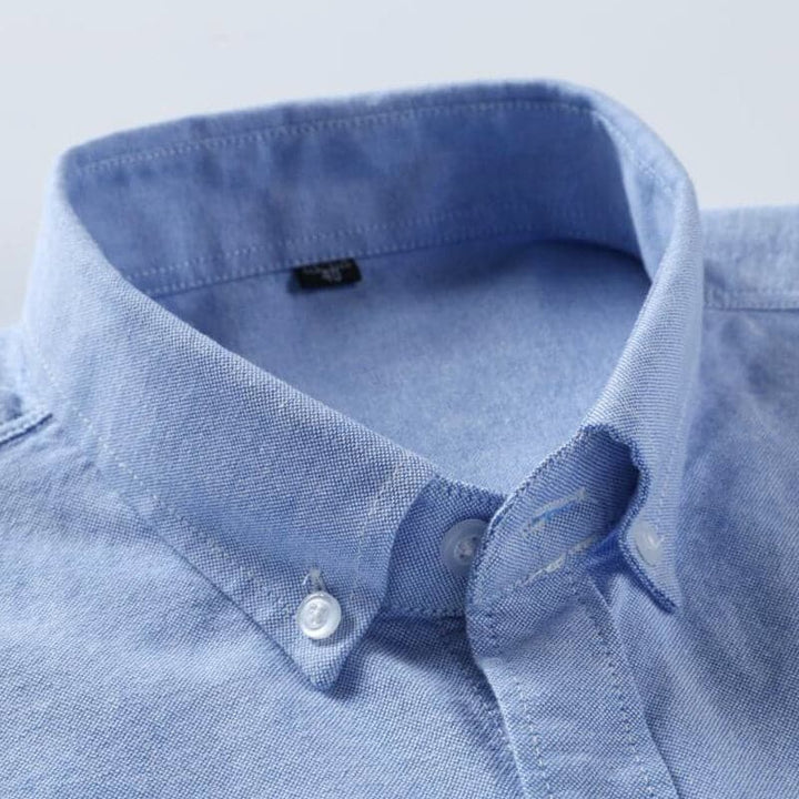 "Chemise homme élégante blanche, bleu, rose, turquoise, design chic, tissu respirant, idéale pour toute occasion."