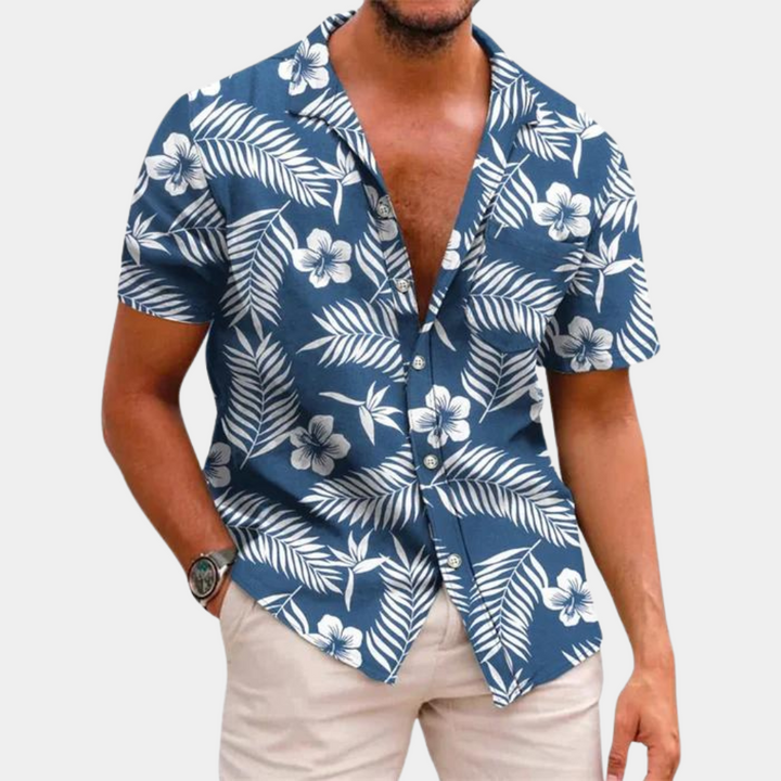 Chemise homme motif floral vif, coupe décontractée, parfaite pour un look estival et tropical.