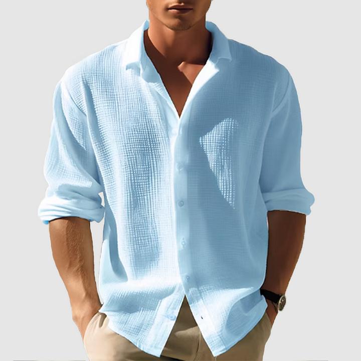 Chemise homme manches longues, élégante et boutonnée. Coupe ajustée, tissu doux.