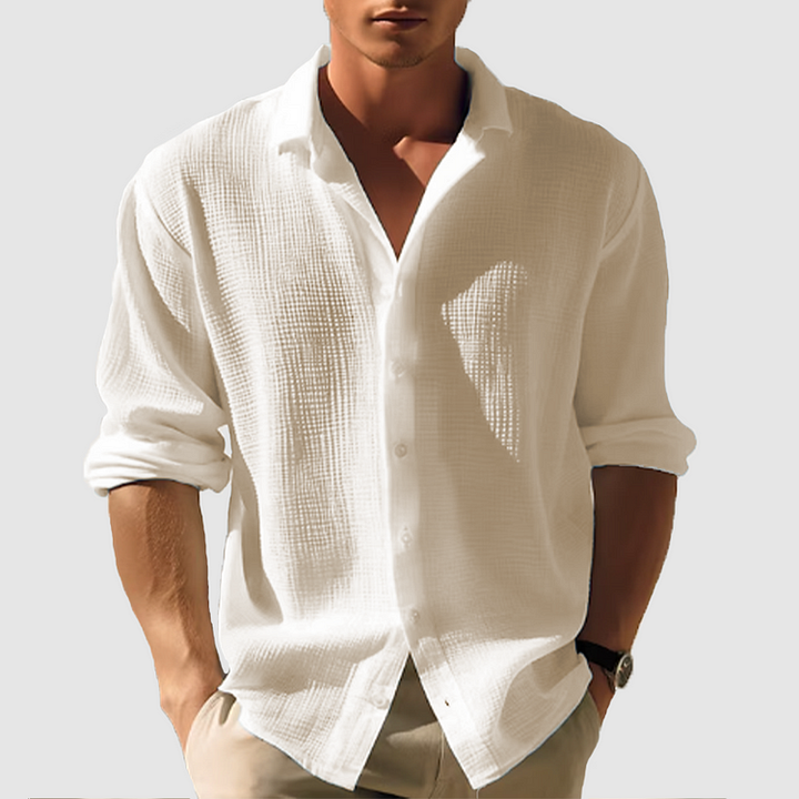 Chemise homme manches longues, élégante et boutonnée. Coupe ajustée, tissu doux.