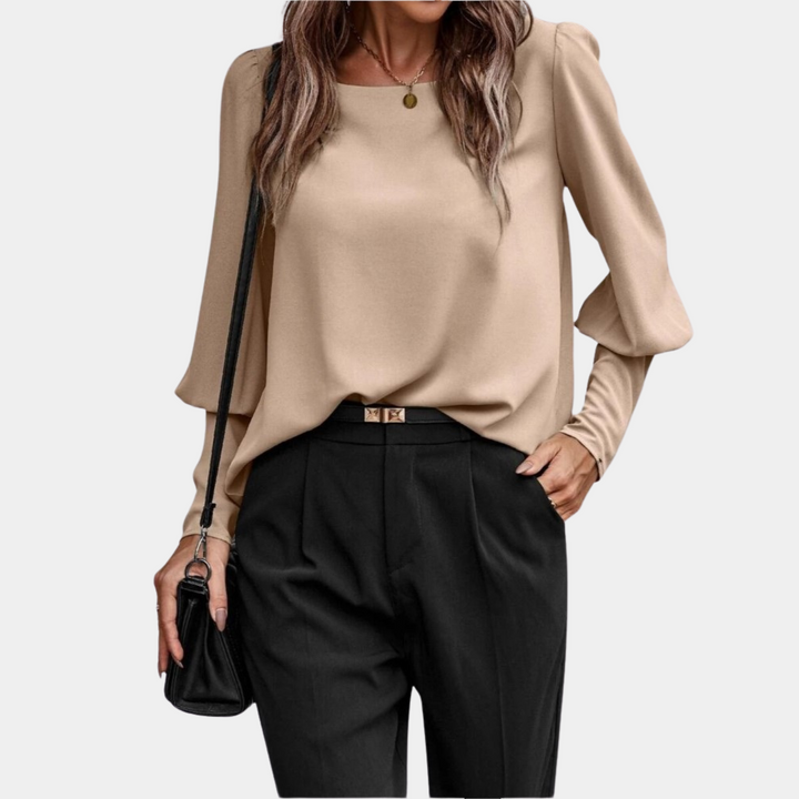 Haut blouse femme chic à manches ballon. Tenue décontractée ou formelle, style moderne et confortable.