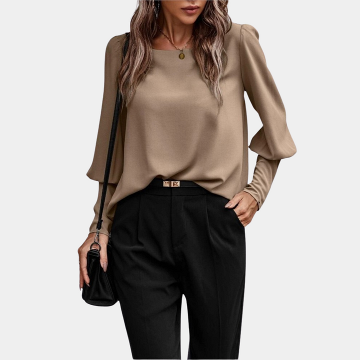 Chemisier femme moderne avec ses manches ballon distinctives. Un haut chic pour toute occasion décontractée ou élégante.