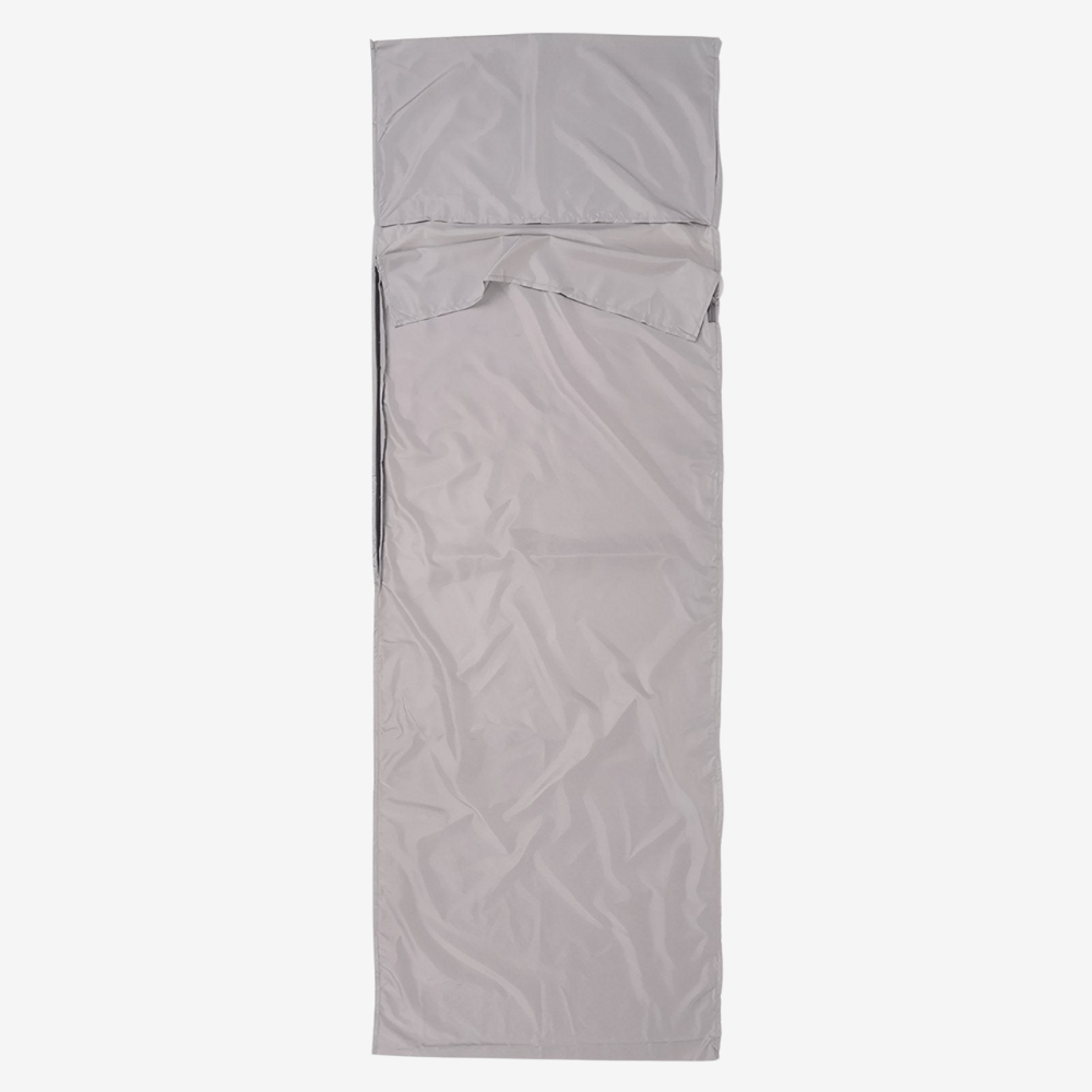 "Drap de sac de couchage léger et respirant pour bivouac, idéal pour aventures en plein air et trekking, structure douce."