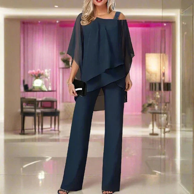 Blouse asymétrique et pantalon jumpsuit fluide: ensemble femme deux pièces, élégant pour soirées.