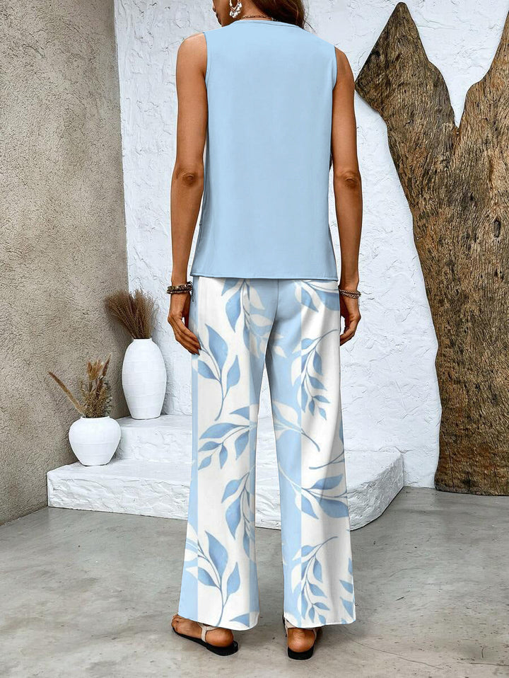 Tenue femme chic et flatteuse, ensemble floral polyvalent, pantalon fluide et haut élégant mode.