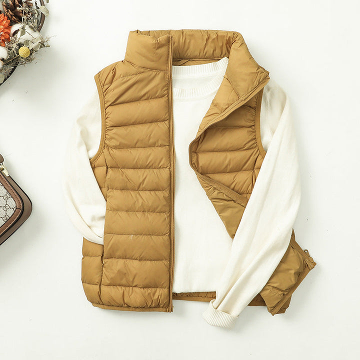 Gilet doudoune femme élégant, coupe ajustée, matelassé, parfait pour la mi-saison.