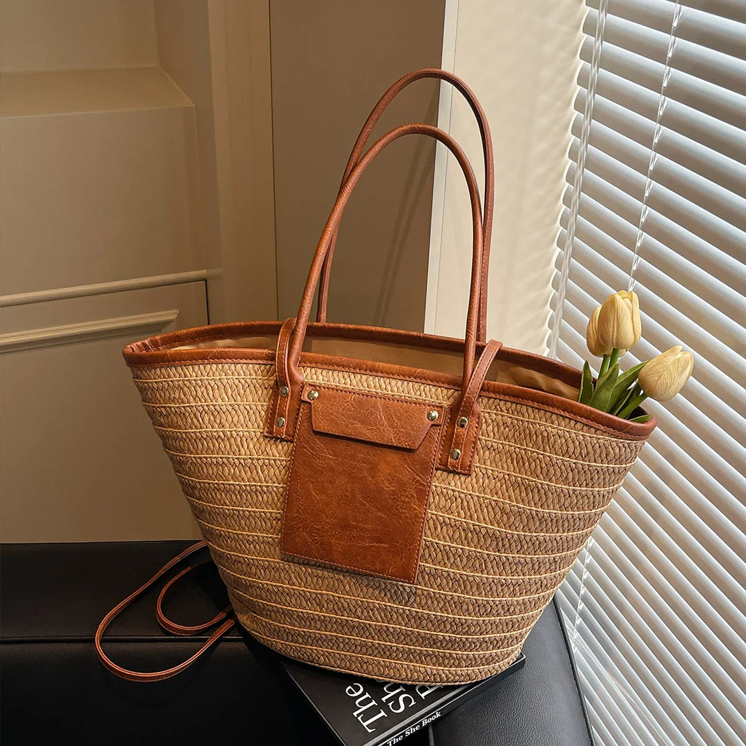 Sac d'été chic femme, modèle Simona, combinant paille naturelle et détails similicuir pour la plage.