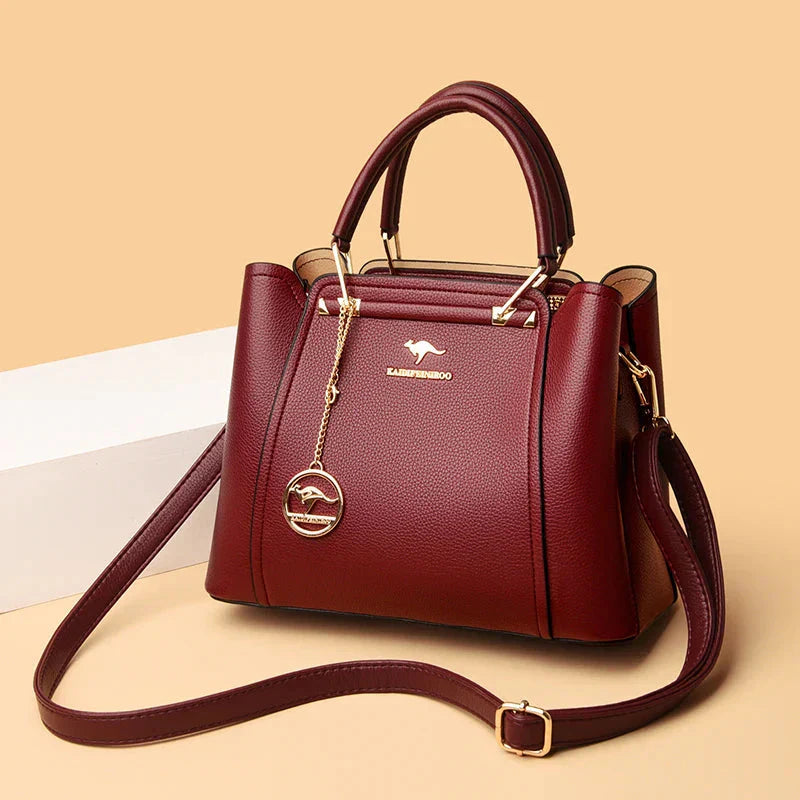 Détails du fermoir doré sur un grand sac à main en cuir élégant pour femme, touche de luxe.