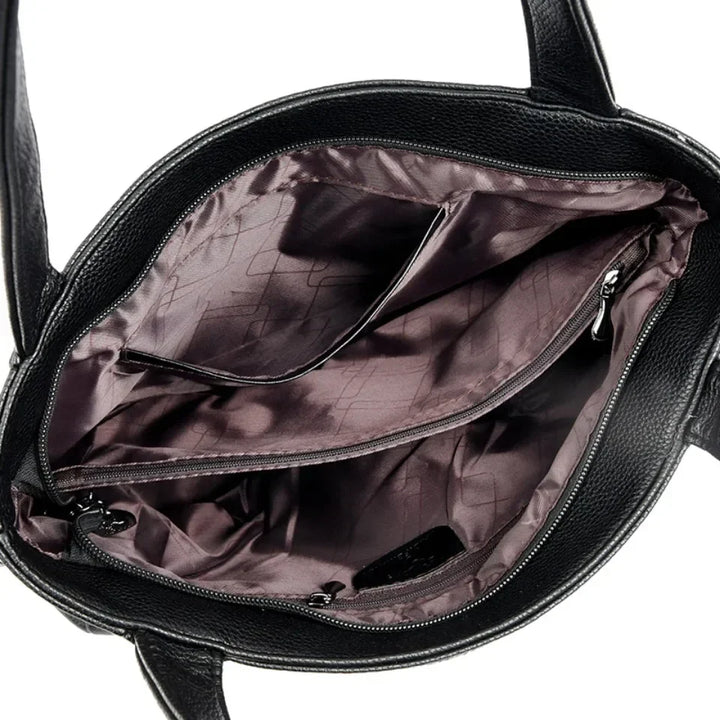 Sac fourre-tout noir moderne et élégant en cuir PU avec détails dorés pour femme, vue de face.