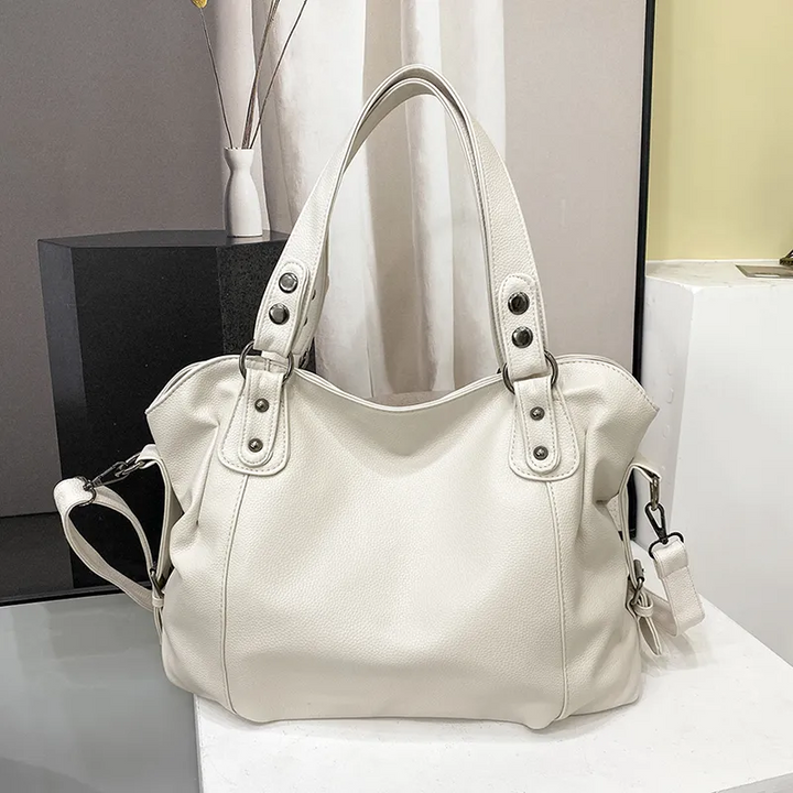 Sac bandoulière épaule en cuir pour femme, moderne et spacieux, avec plusieurs poches.
