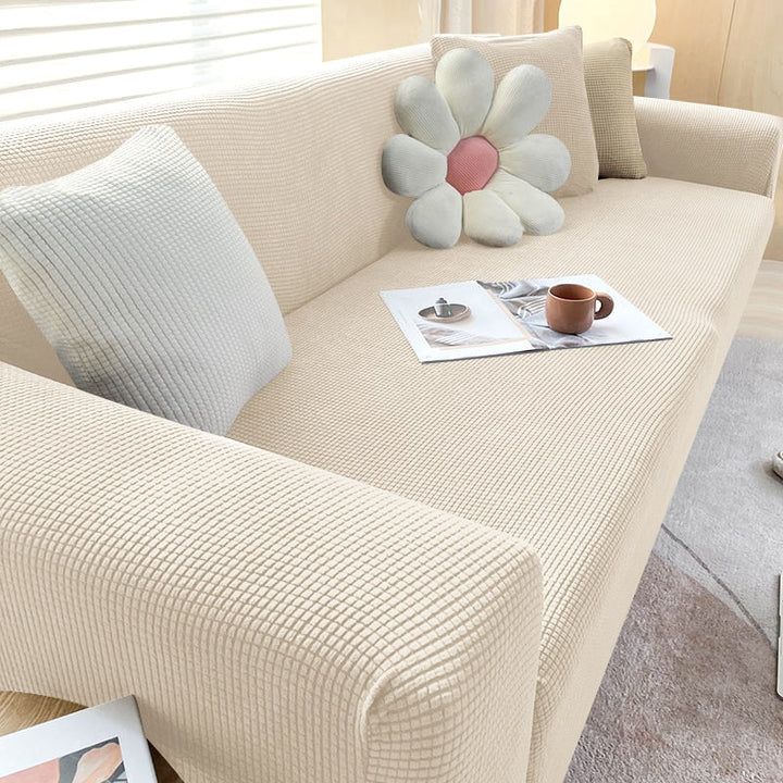 Housse de canapé extensible beige avec motif élégant et design antidérapant, disponible en plusieurs tailles pour salons mode