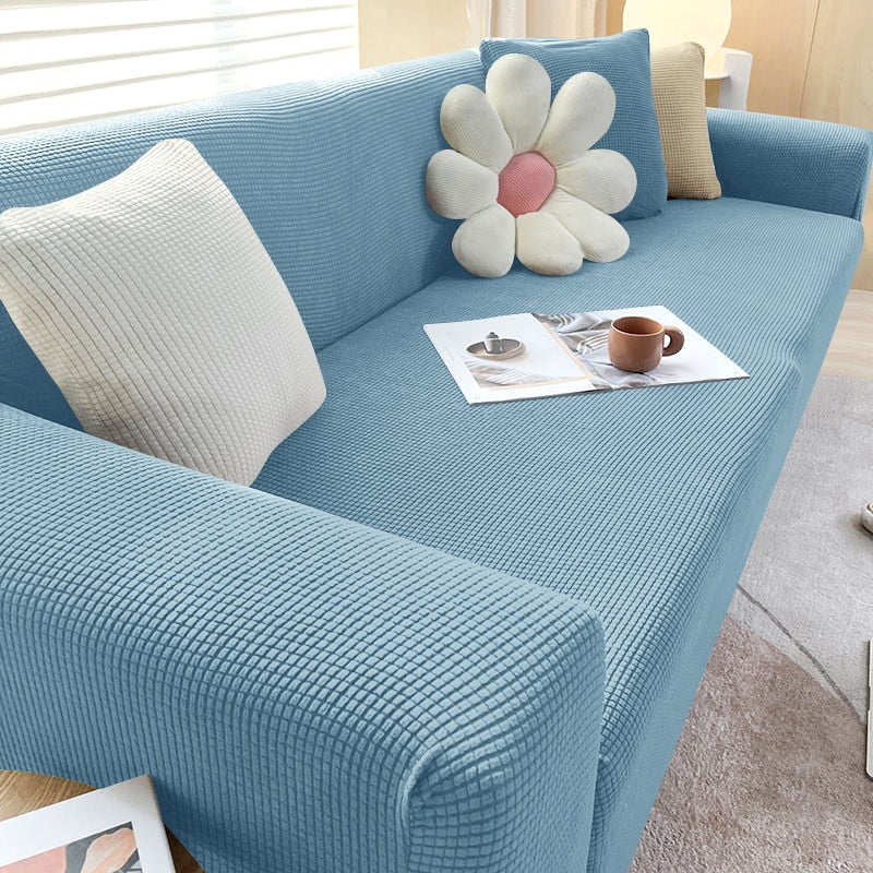 Housse de canapé extensible beige avec motif élégant et design antidérapant, disponible en plusieurs tailles pour salons mode