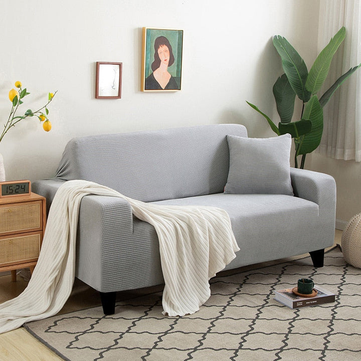 Housse de canapé extensible beige avec motif élégant et design antidérapant, disponible en plusieurs tailles pour salons mode