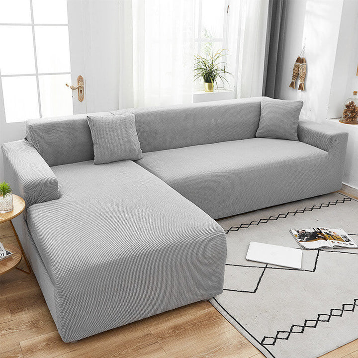 Housse de canapé extensible beige avec motif élégant et design antidérapant, disponible en plusieurs tailles pour salons mode