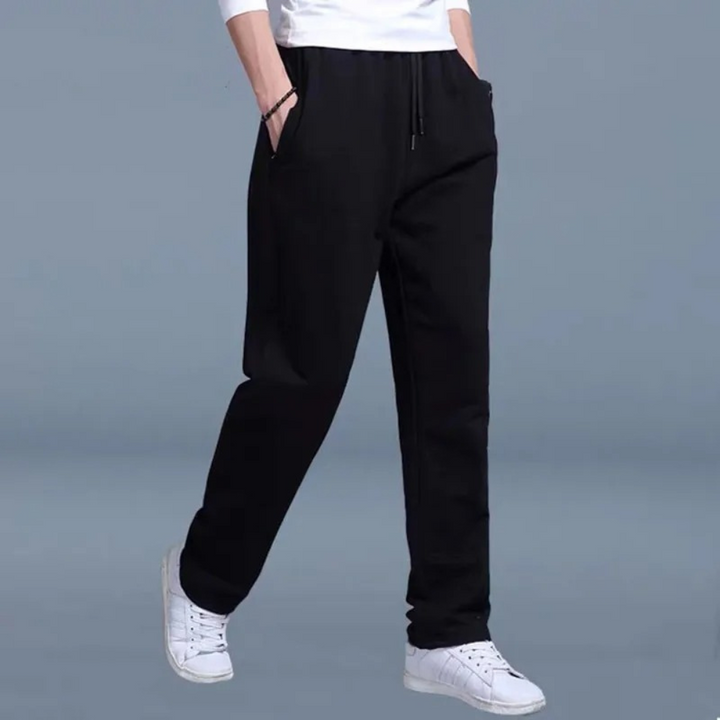 Pantalon jogging homme noir, confort supérieur, taille élastique et chevilles resserrées.