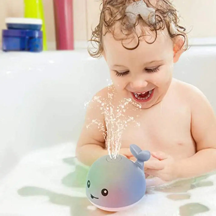 Jouet bain bébé: baleine avec jet d'eau LED.  Amusant et coloré.