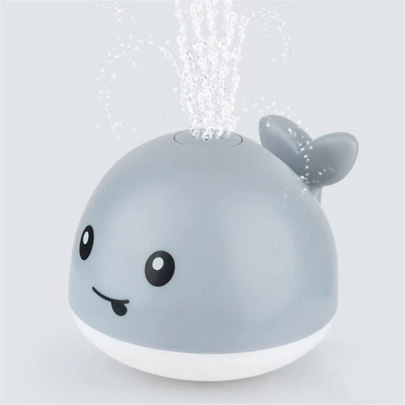 Jouet bain bébé: baleine avec jet d'eau LED.  Amusant et coloré.