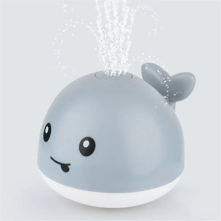 Jouet bain bébé: baleine avec jet d'eau LED.  Amusant et coloré.
