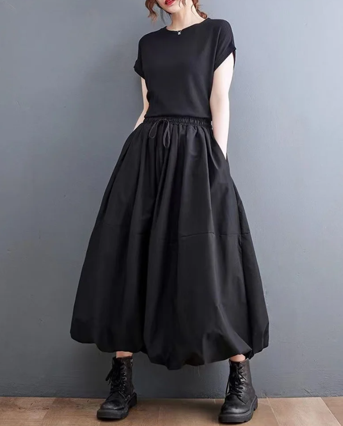 Jupe ballon noire tendance femme, look moderne et chic. Élégante et polyvalente, s'adapte à toute occasion.