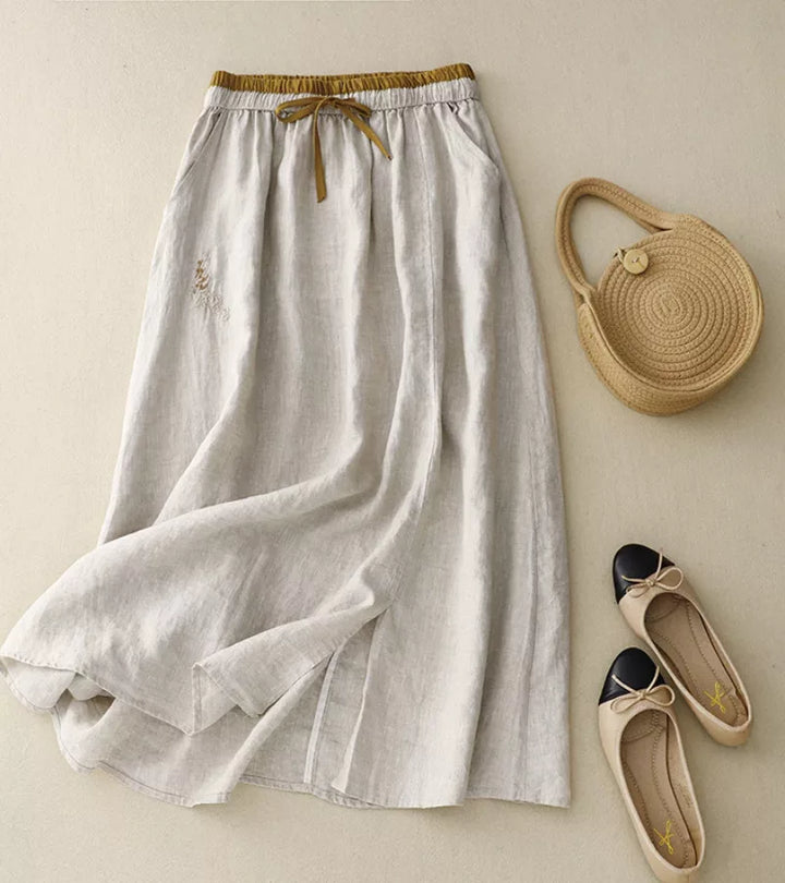 Jupe femme élégante mi-longue A-line taille haute. Parfaite pour l'été, fluide et confortable.