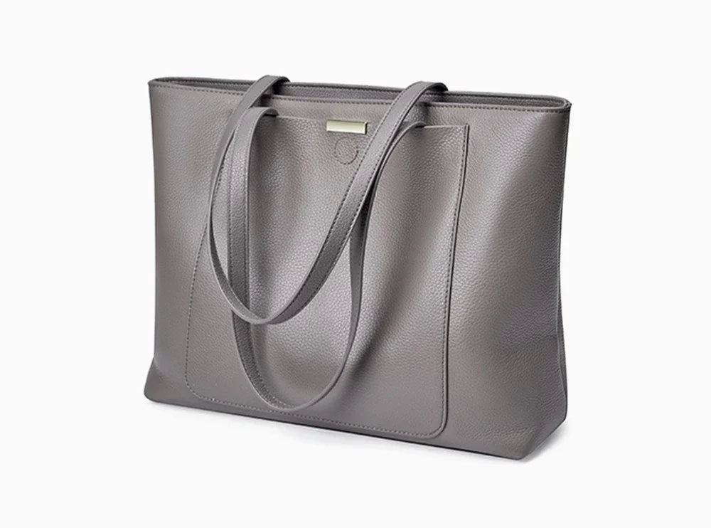 Sac fourre-tout élégant en cuir gris pour femme, accessoire polyvalent pour le travail et les cours.