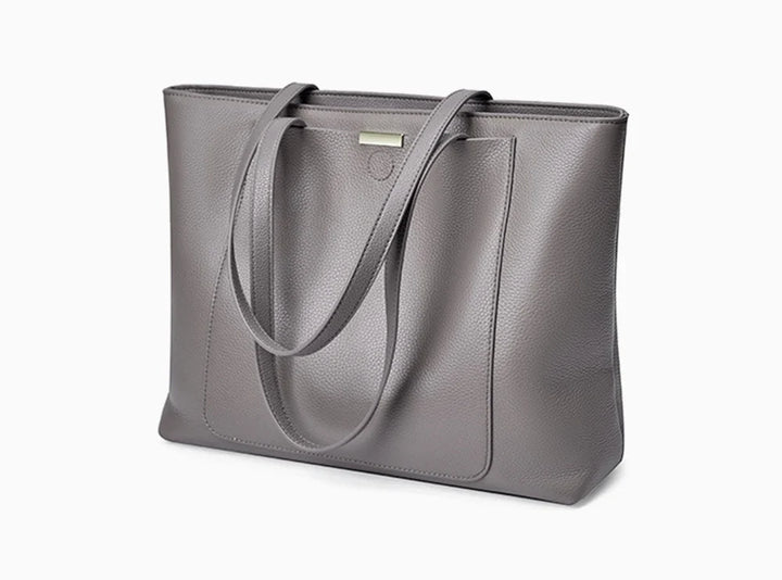 Sac fourre-tout élégant en cuir gris pour femme, accessoire polyvalent pour le travail et les cours.