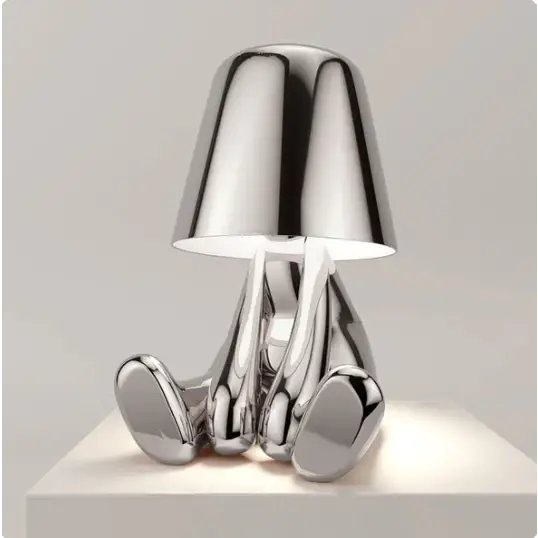 Lampe LED tactile or moderne, sans fil et rechargeable, design formes humaines, ambiance chaleureuse et décorative.
