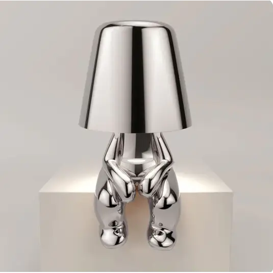 Lampe LED tactile or moderne, sans fil et rechargeable, design formes humaines, ambiance chaleureuse et décorative.