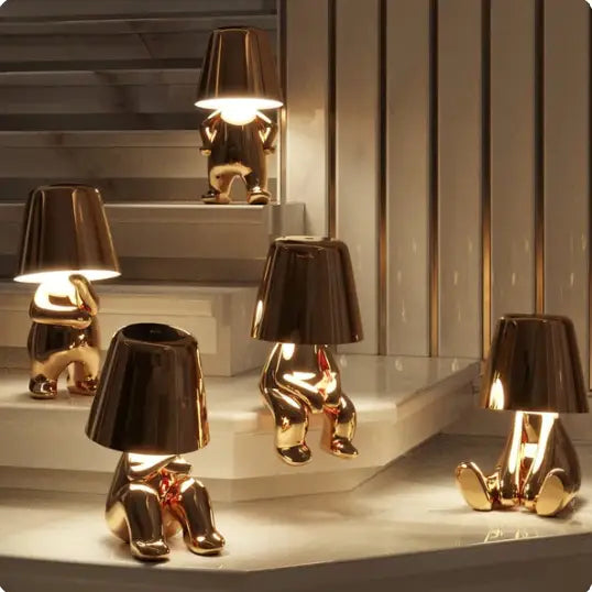 Lampe LED tactile or moderne, sans fil et rechargeable, design formes humaines, ambiance chaleureuse et décorative.