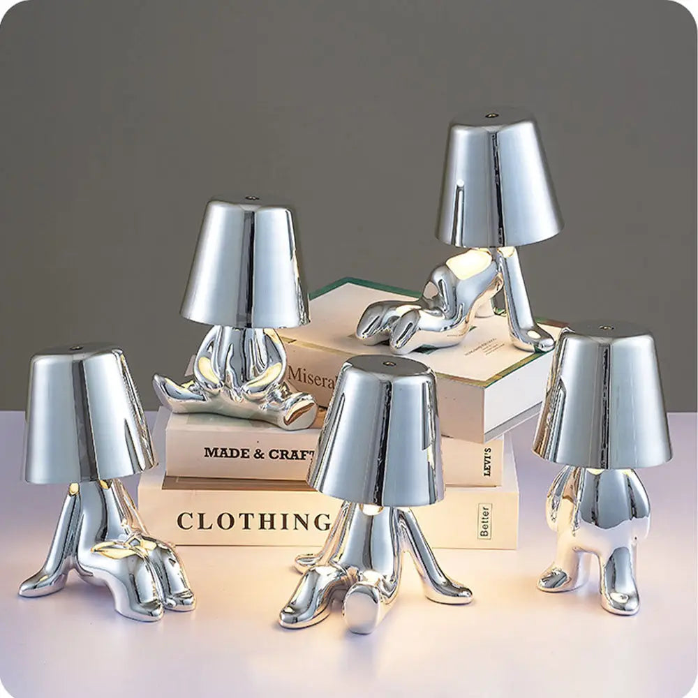 Lampe LED tactile or moderne, sans fil et rechargeable, design formes humaines, ambiance chaleureuse et décorative.