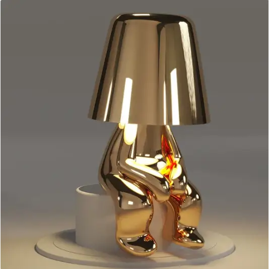 Lampe LED tactile or moderne, sans fil et rechargeable, design formes humaines, ambiance chaleureuse et décorative.